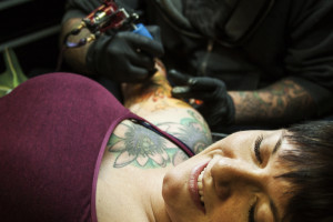 Austin resident Jessica Orr completes her floral sleeve at True Blue Tattoo in Austin, TX. The Indian Paintbrushes she’s having filled in affectionately remind her of her time spent in nature as a child.
